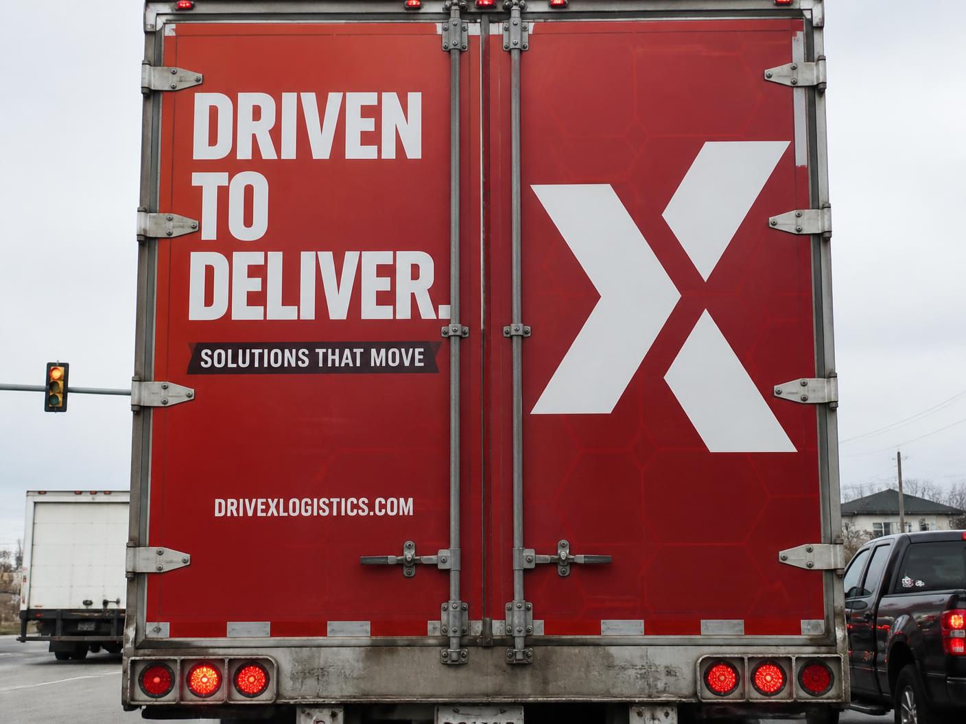 Truck rear doors covered edge-to-edge with a printed advertisement